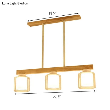 Modern wooden chandelier with three white glass shades and brass accents for dining room lighting heads dining room