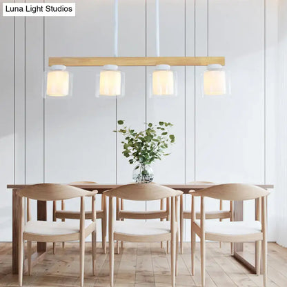 Modern minimalist wood and white glass pendant light with four heads for warm diffused dining room lighting