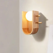 Modern minimalist wooden sconce light with warm glow and two small pegs for hanging as wall light in bedroom