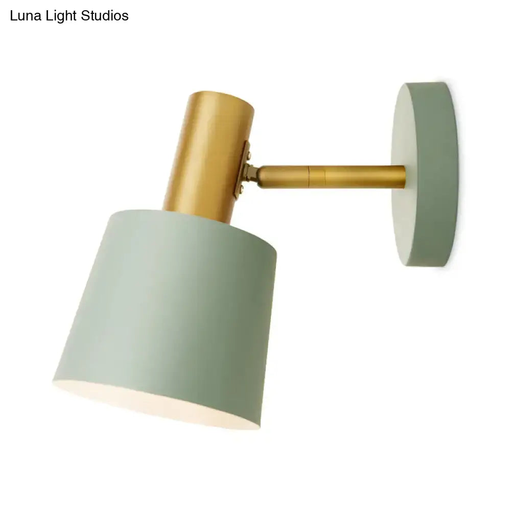 Modern mint green metal drum sconce with a matte sage green shade and brass-finished arm wall mounted lamp
