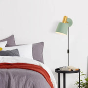 Modern mint green and gold metal drum sconce wall mounted lamp with a black slender stand for bedroom lighting