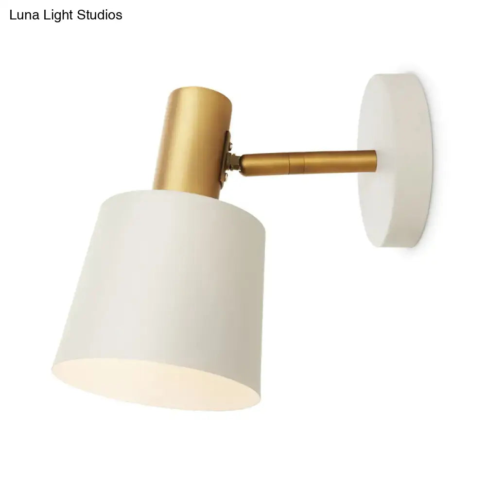 A sleek white metal drum sconce with brass-finished arm and mounting plate wall mounted lamp for bedrooms