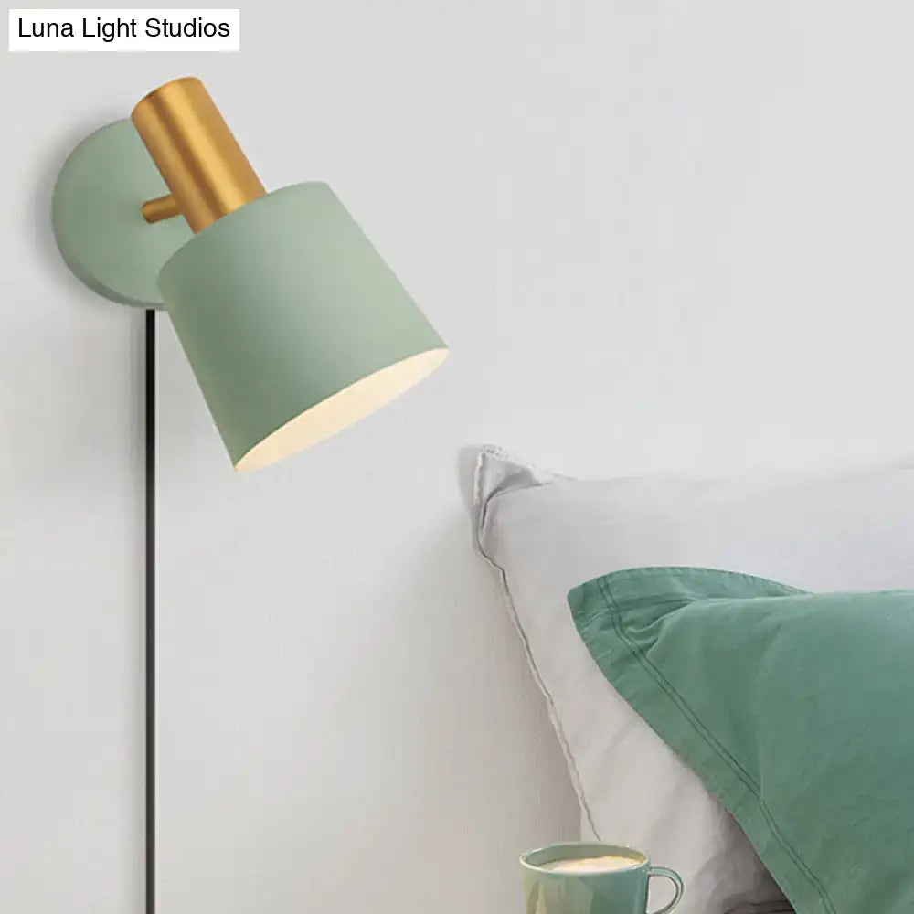 Modern mint green metal drum sconce wall mounted lamp with matte sage green shade and polished brass accents