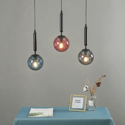 Modern multi color glass pendant light with blue pink gray spherical shades and painted iron rods for dining room
