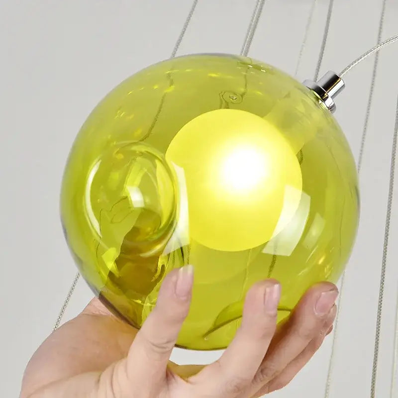 Modern multicolored clear glass chandelier with a vibrant lime green clear glass pendant light and metallic suspension hardware for decorbites colorful sconces decor