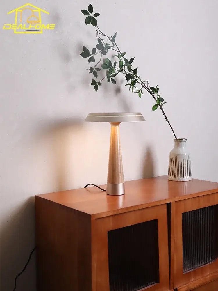 Modern brass-toned solid wood table lamp with a sleek tapered base and minimalist circular shade for bedroom decorbites ceil solid use
