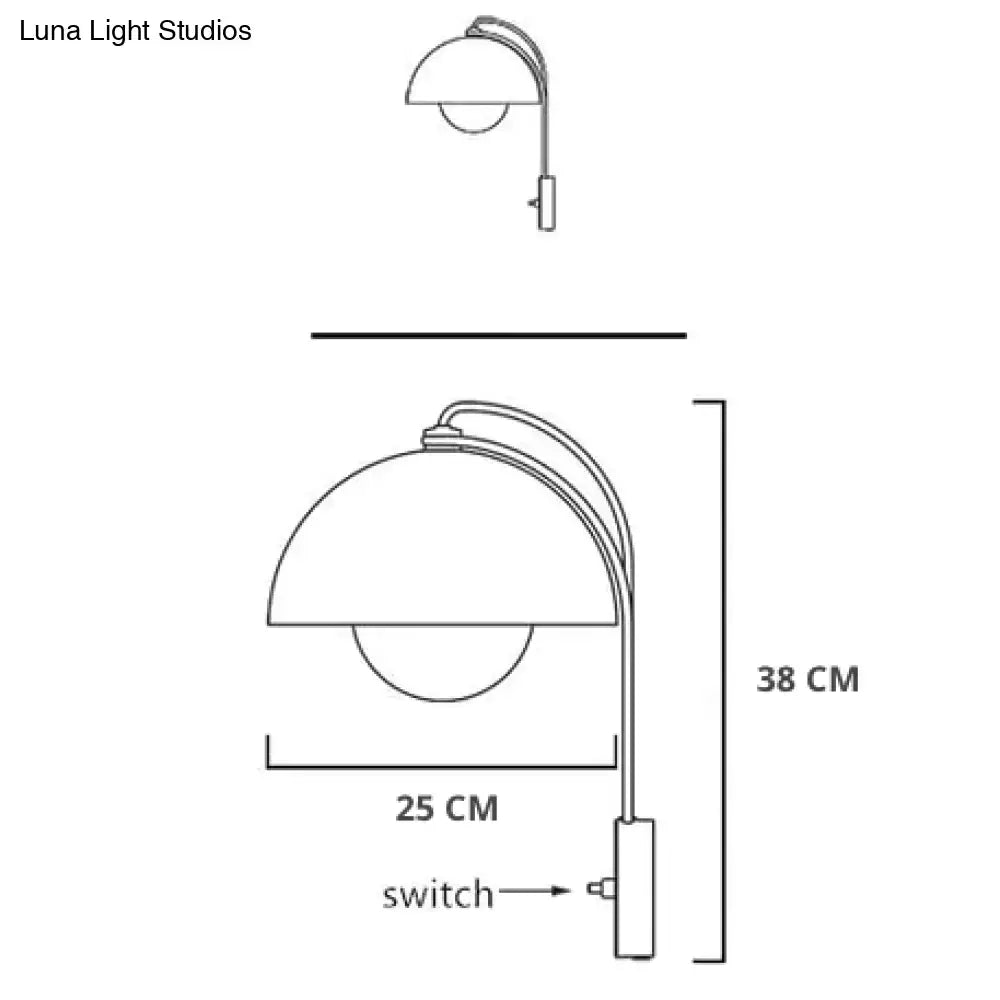 Modern mushroom wall lamp with brass base type and curved arm featuring a dome-shaped shade for bedroom use