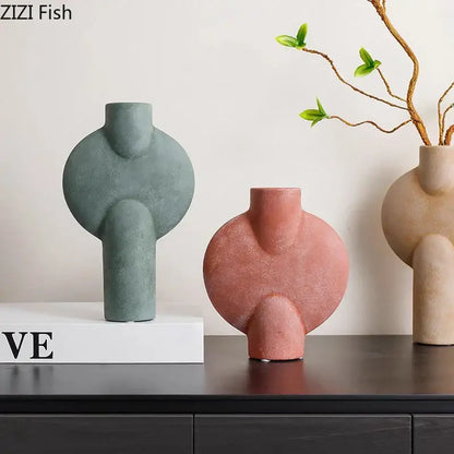 Three modern decorbites ceramic disc vases in muted green terracotta and beige with abstract organic shapes for living room decor