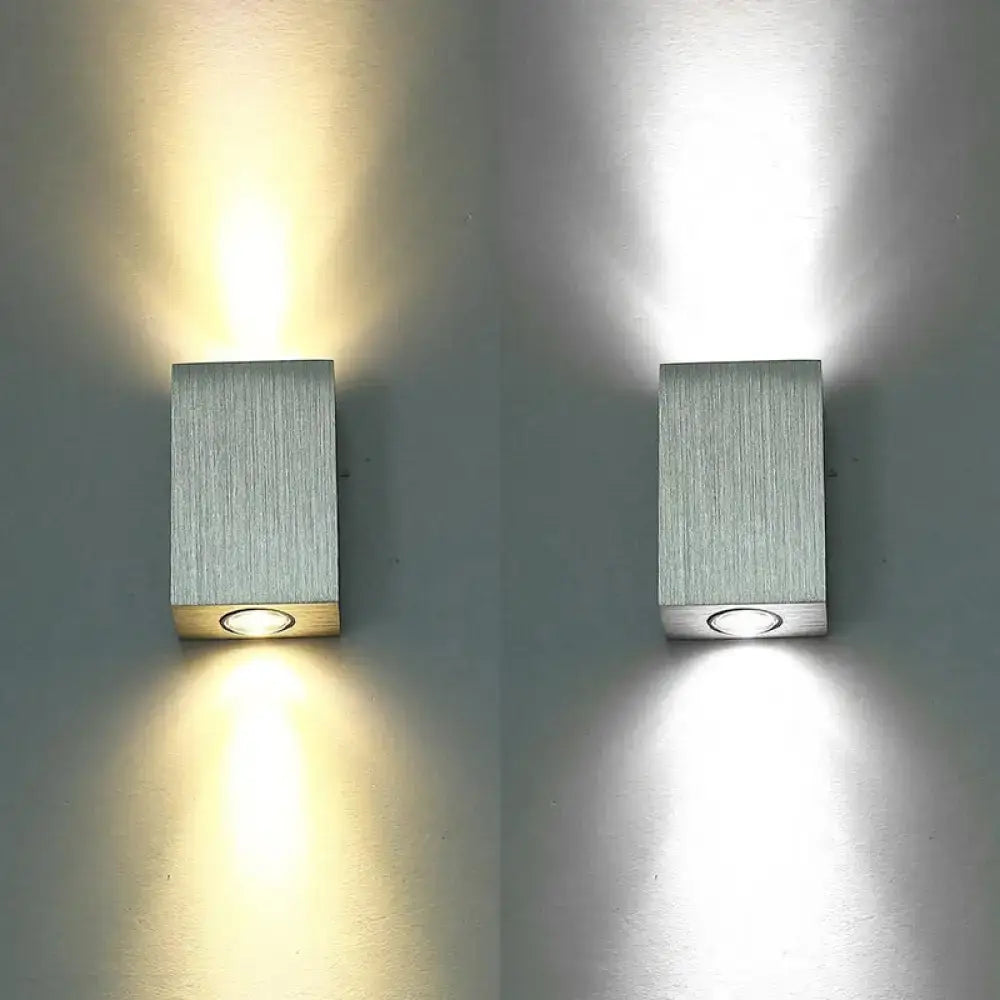 Modern nickel finish rectangular led wall sconce with brushed silver finish and circular led light at the base