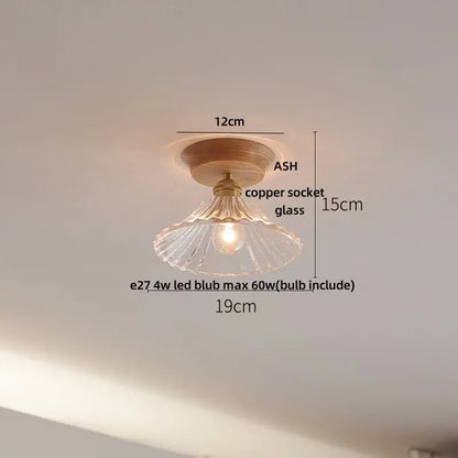 A warm-toned modern nordic ceiling lamp with wooden base and decorbites clear glass led fluted shade for kitchen