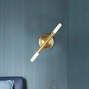 Modern Nordic brass finish wall sconce with gold-toned minimalist cylindrical design and frosted glass diffuser for bedrooms