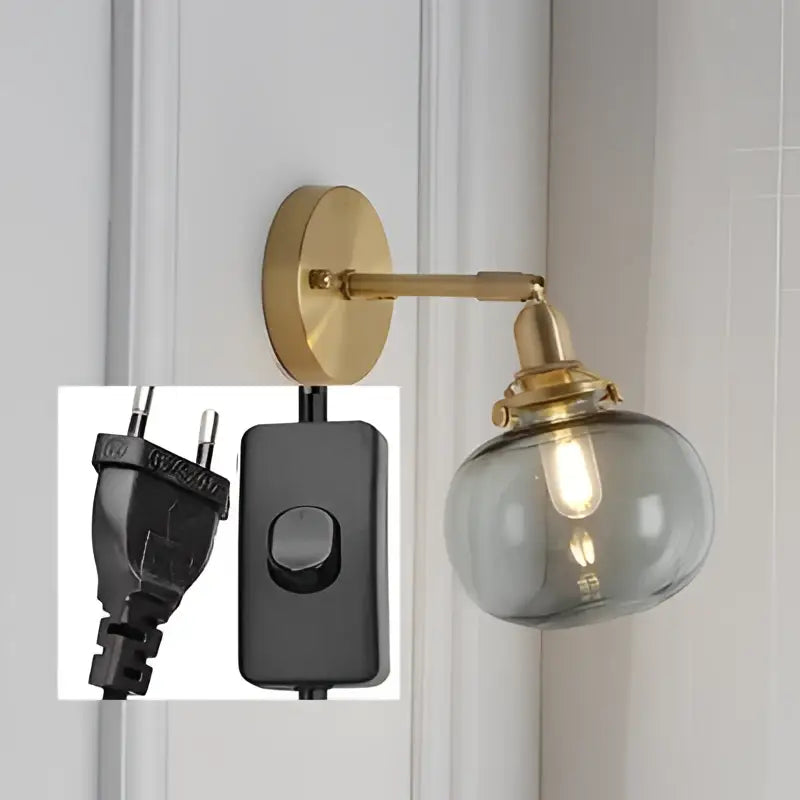 Modern nordic brass glass ball wall lamp with smoked glass globe and black power switch cord for bedroom decorbites glass ball