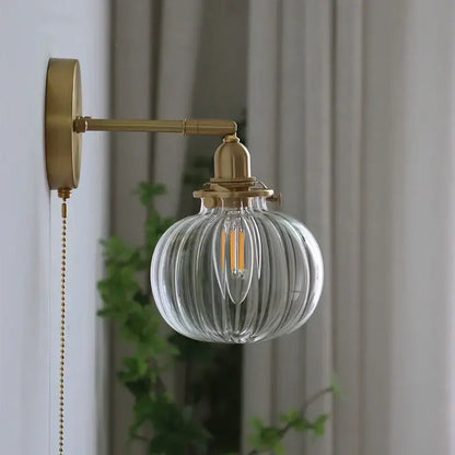 Modern nordic brass glass ball wall lamp with clear ribbed glass globe and metal mounting plate for bedroom decorbites glass ball