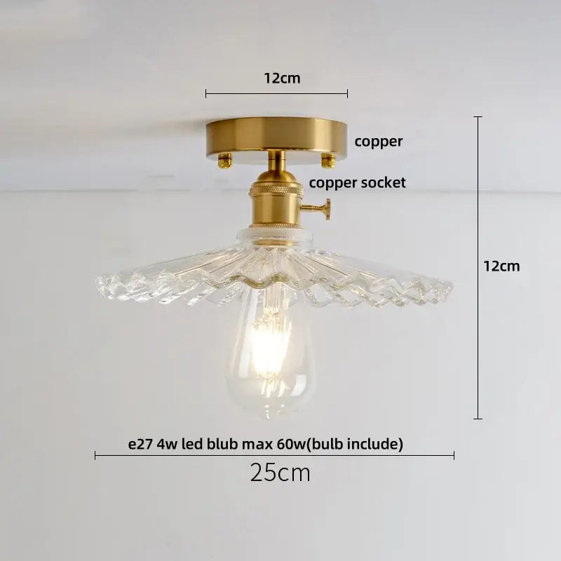 Modern nordic ceiling light fixture with brass copper base and clear faceted glass shade for bedroom use