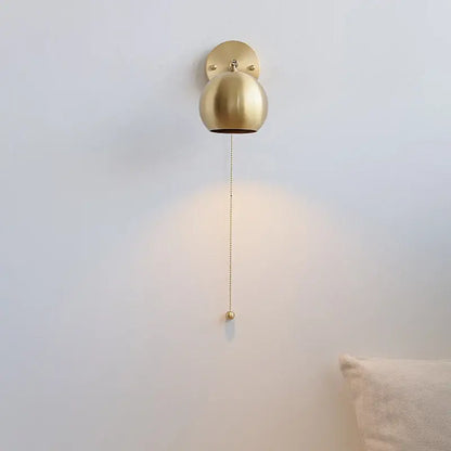 Modern nordic gold-finished spherical copper wall light with pull chain switch and decorative ball for bedroom decorbites copper wall light
