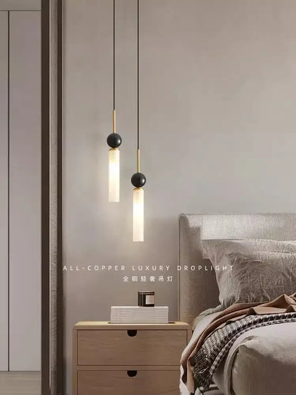 Two minimalist pendant lights with black tops gold accents and frosted glass shades for modern nordic decorbites copper wall lamp