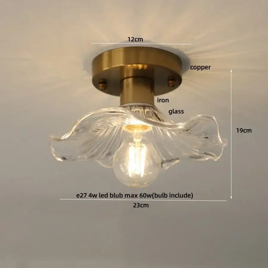 A clear glass flower led ceiling light with brass-finished copper iron base for modern nordic bedroom decor