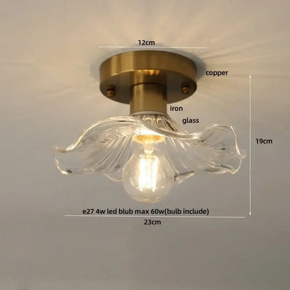 A clear glass flower led ceiling light with brass-finished copper iron base for modern nordic bedroom decor