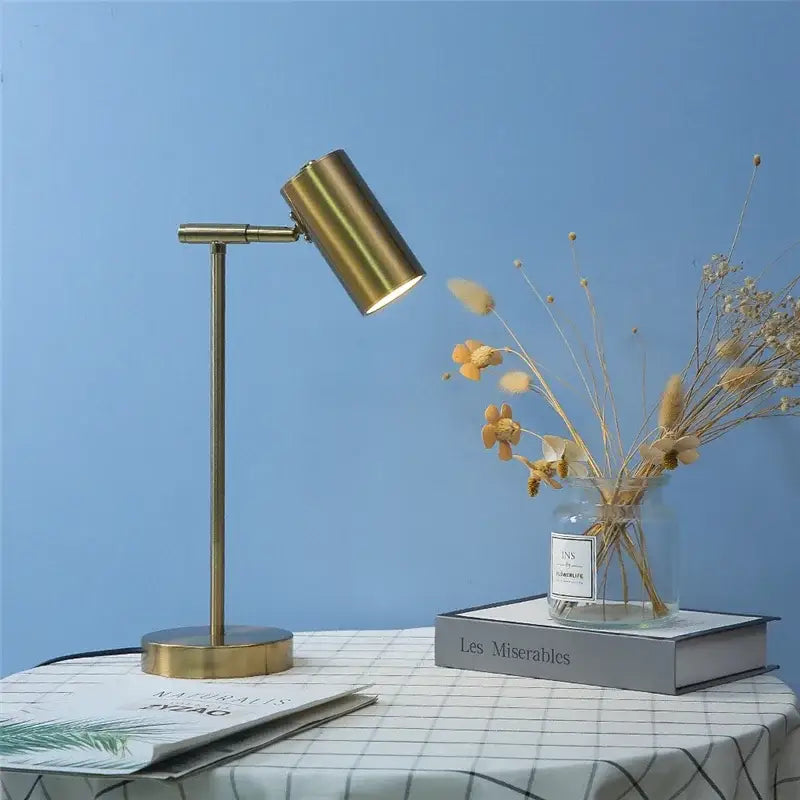 Brass-finished decorbites golden table lamp with adjustable cylindrical head and slender stem for modern nordic bedroom decor