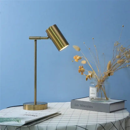 Brass-finished decorbites golden table lamp with adjustable cylindrical head and slender stem for modern nordic bedroom decor