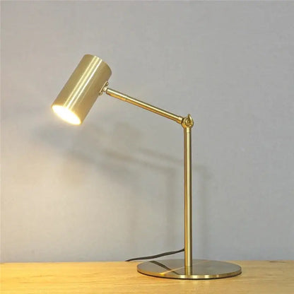 Modern nordic decorbites golden table lamp with adjustable brass arm and cylindrical head for bedroom use