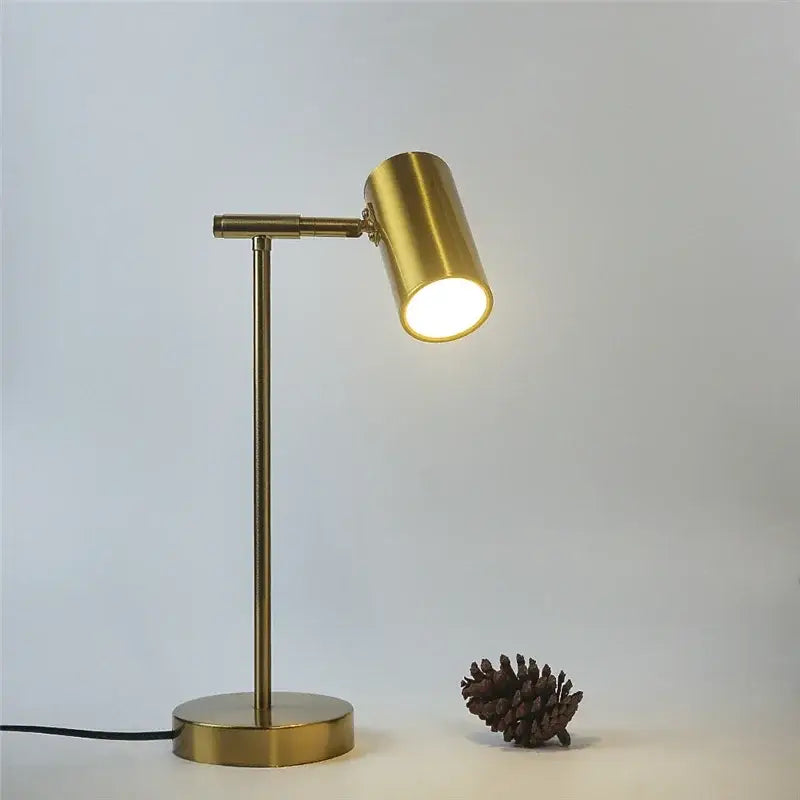 A sleek decorbites golden table lamp with adjustable brass desk light and warm cylindrical head for bedroom decor
