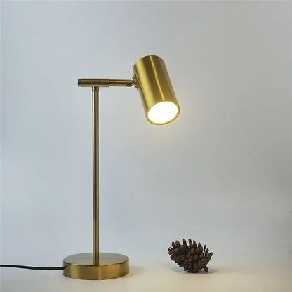 A sleek decorbites golden table lamp with adjustable brass desk light and warm cylindrical head for bedroom decor