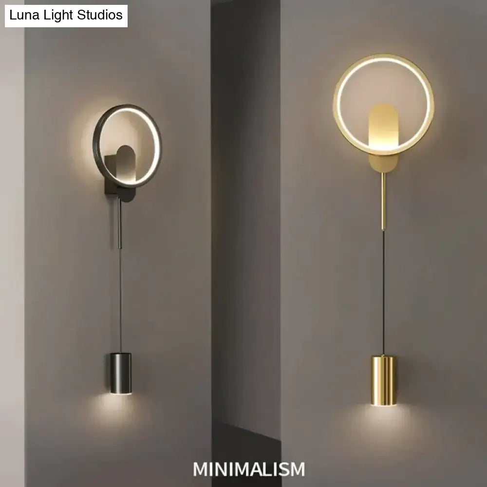 Modern nordic led wall lamp bedroom sconce with black gold finish featuring a circular metallic ring and cylindrical pendant