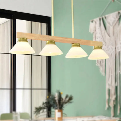 Modern farmhouse nordic linear wood hanging light with natural wood beam brass accents and four frosted glass shades