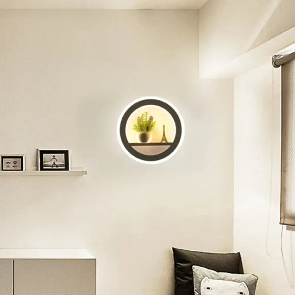 Modern Nordic wall light with black frame and glowing white ring bulb included featuring shelf with plant and Eiffel Tower model
