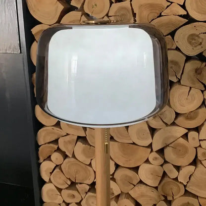 Modern nordic wood and glass floor lamp with a sleek white glass floor shade and polished chrome frame for living room use