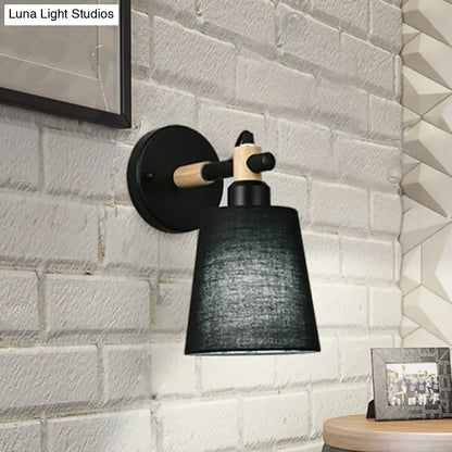 Modern nordic wood wall lamp with black horn shade, matte black metal base, light wood accents, suitable as bedroom sconce