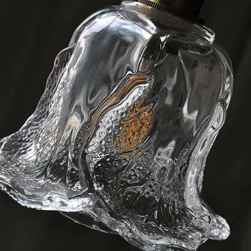 Clear glass bell-shaped pendant lamp with textured bubbly surface and brass top for modern copper glass led decorbites