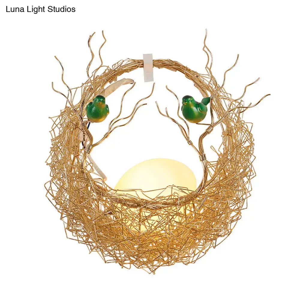 Modern opal glass sconce light with golden wire bird nest and green ceramic birds for living room decor