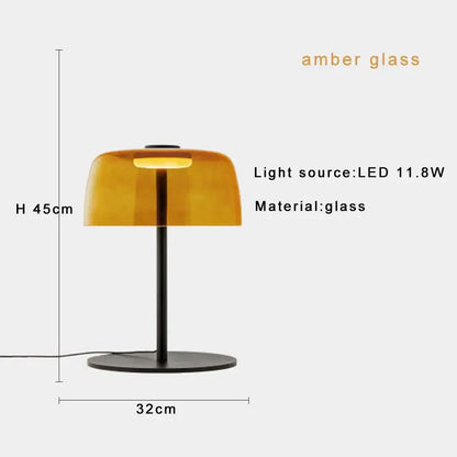 Modern orange glass table lamp with amber glass shade and sleek black metal base for minimalist bedroom decorbites glass table lamp