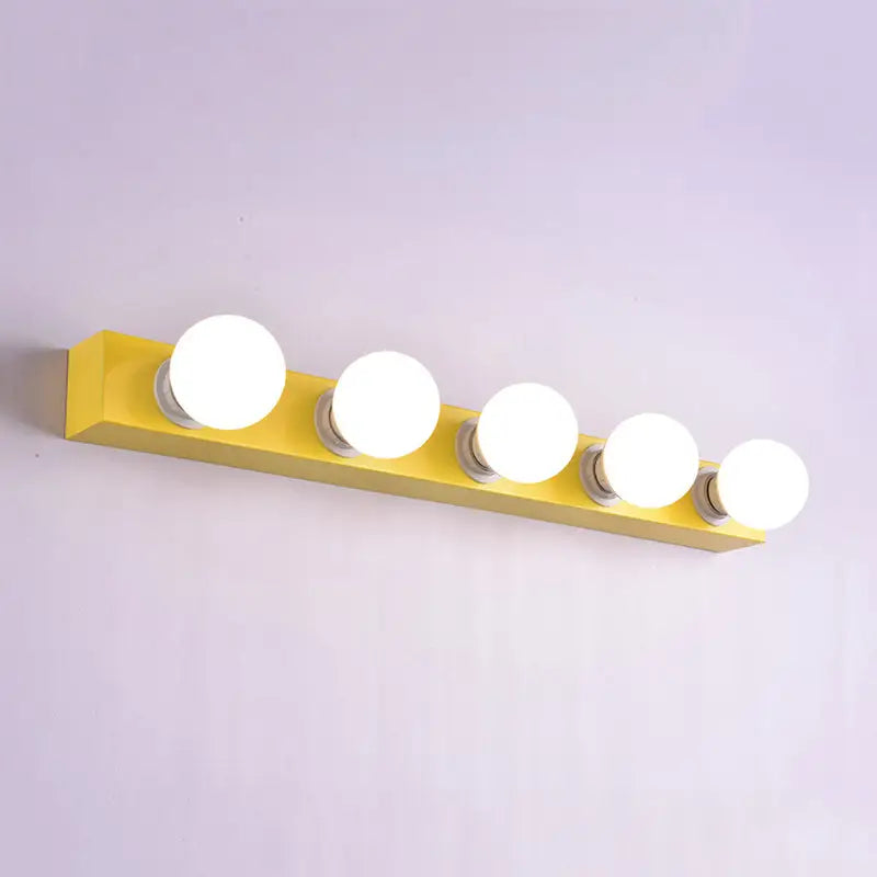 Modern bright yellow rectangular vanity light fixture with five round white bulbs for bedroom use