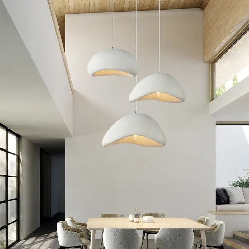 Three off-white dome-shaped pendant lamps with warm led lighting in a handmade led chandelier for dining room decorbites