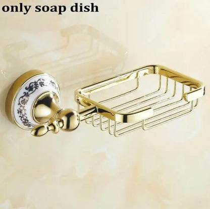 Gold-toned metal soap dish with decorative blue floral ceramic plate in modern ornate gold and white porcelain bath hardware set