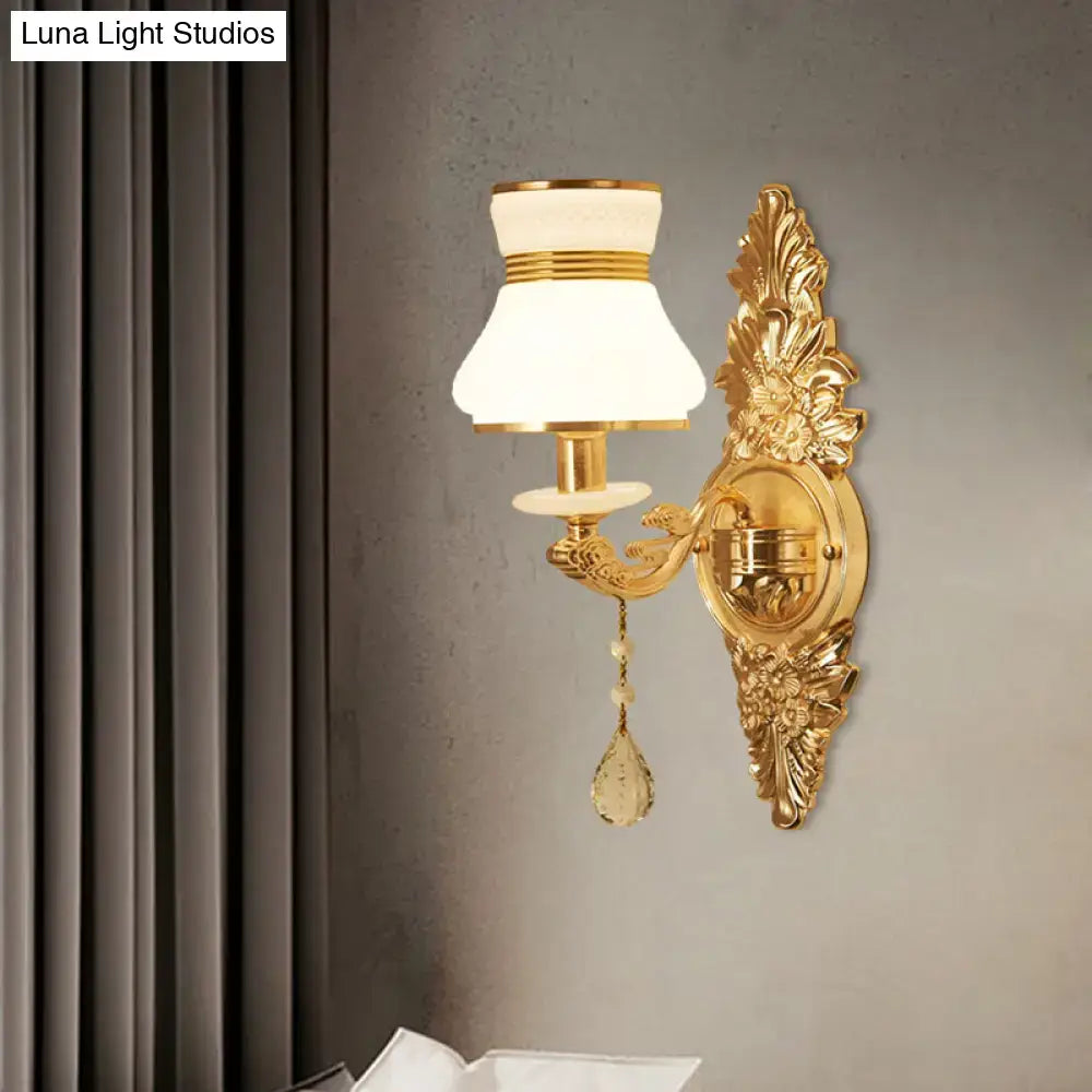 Modern ornate gold wall light with frosted glass shade and crystal teardrop for bedroom sconce lighting