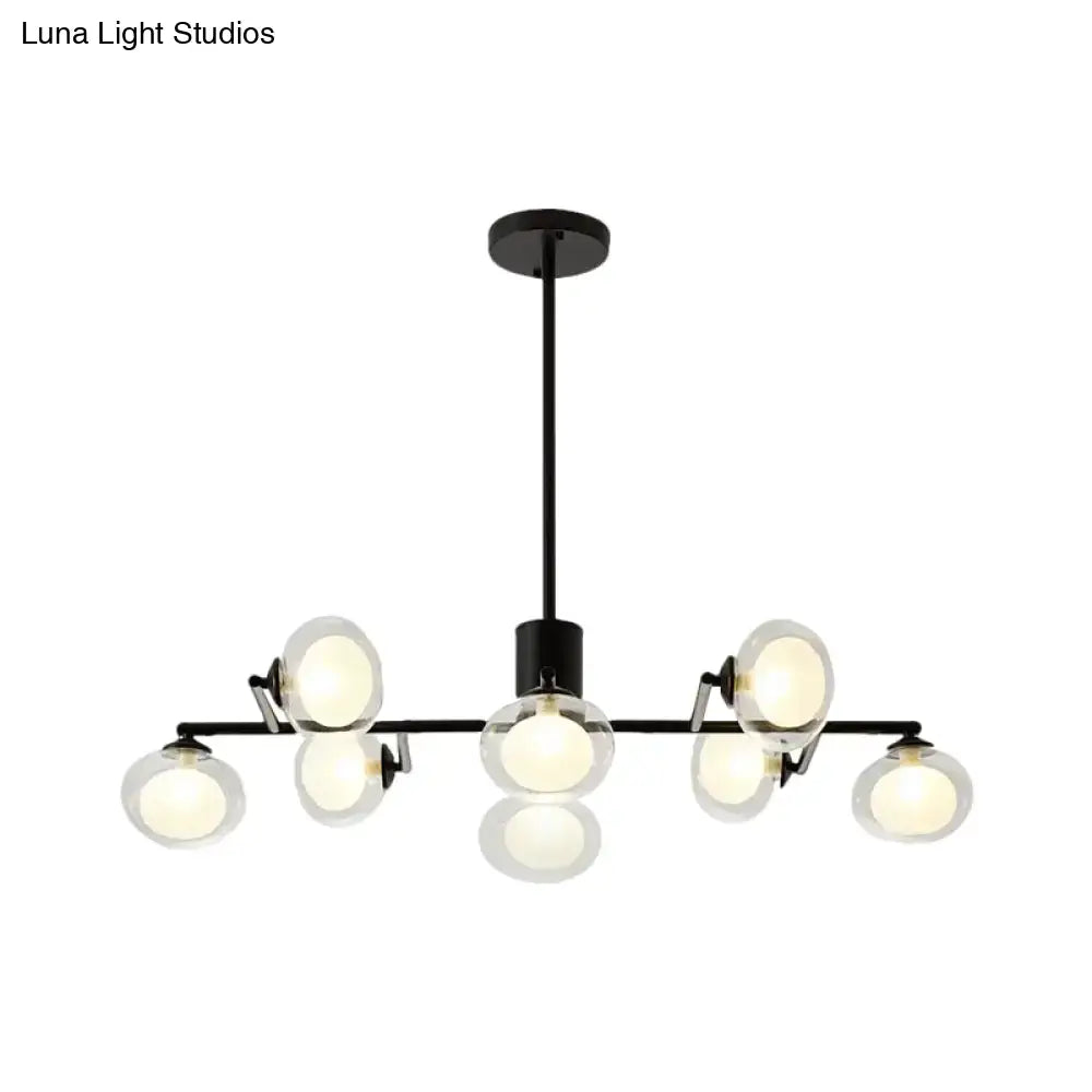 Black metal chandelier with eight frosted glass globe bulbs for modern black white decor by DecorBites™