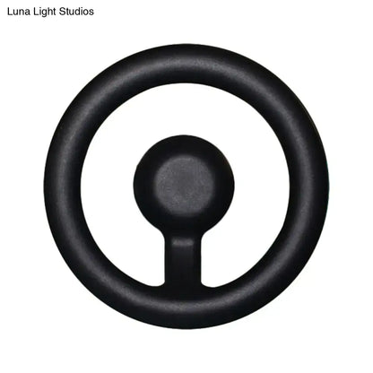 Black rubber steering wheel grip shown with modern oval black white led mirror bedroom wall light 110v-120v maximum bulb wattage