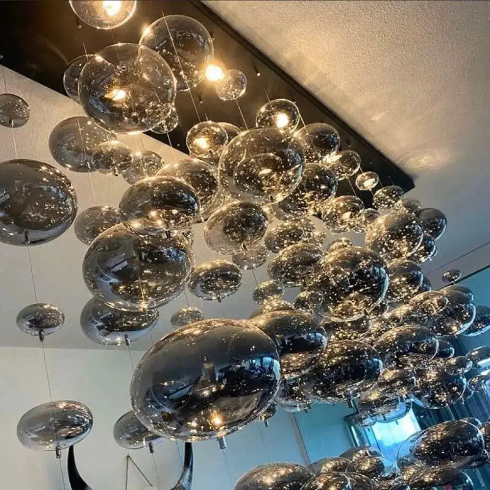 DecorBites modern oval bubble ball LED chandelier with transparent glass spheres and metallic interiors for dining room lighting