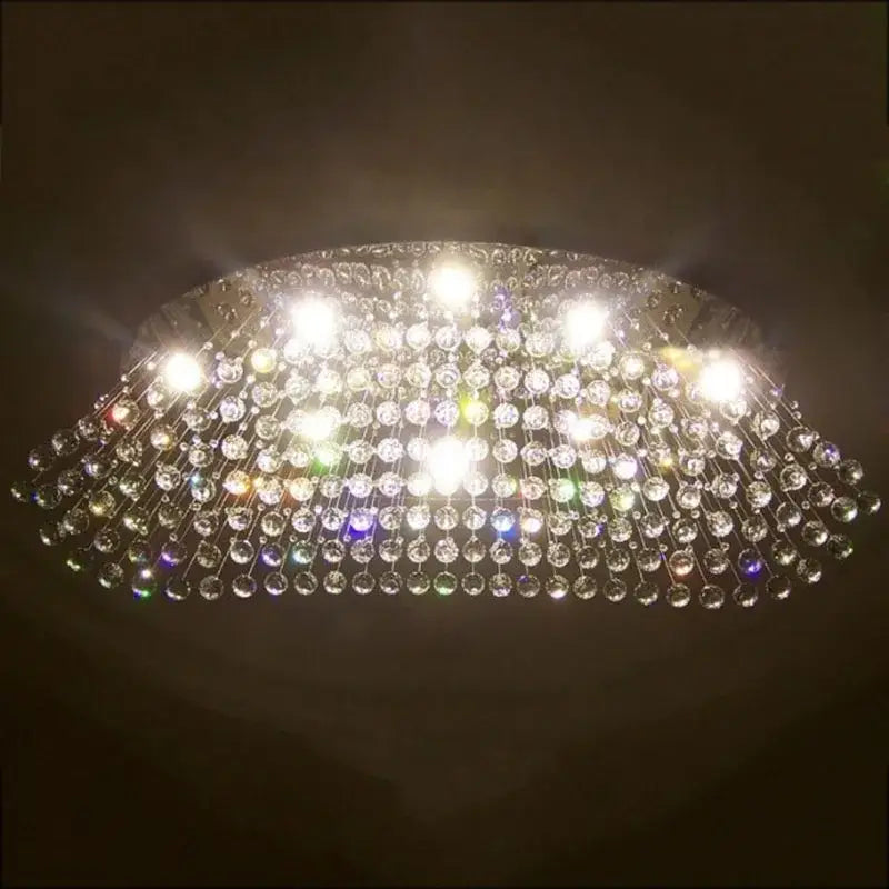 Modern oval crystal flush mount chandelier with clear crystal beads and metallic frame for dining room lighting