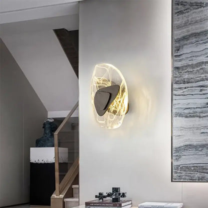 Modern oval crystal wall lamp with translucent organic glass diffuser and dark metallic accent for bedroom use
