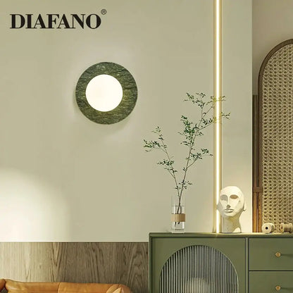 Modern oval green marble wall lamp with a circular polished stone sconce and central illuminated circle decorbites green marble