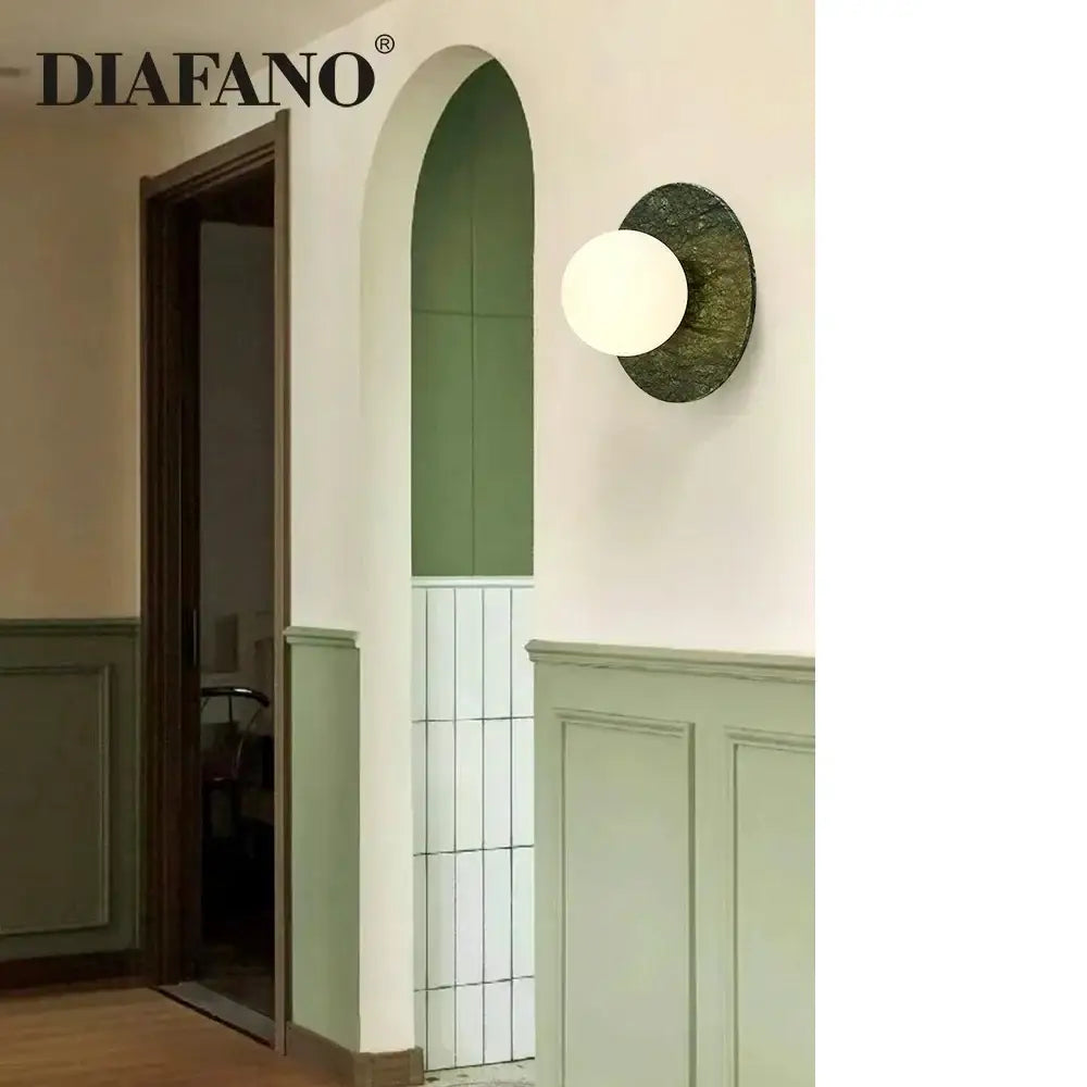 Diafano wall lamp with matte white glass shade and ornate dark green textured metal backplate for living room decorbites green marble