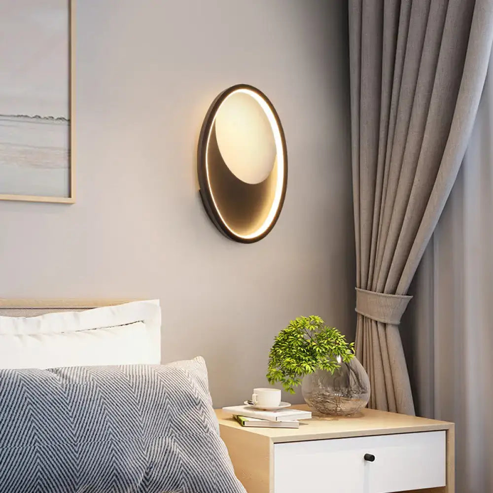 Modern oval white and black led wall lamp with warm glowing circular light and sleek metallic frame for 110v-120v use