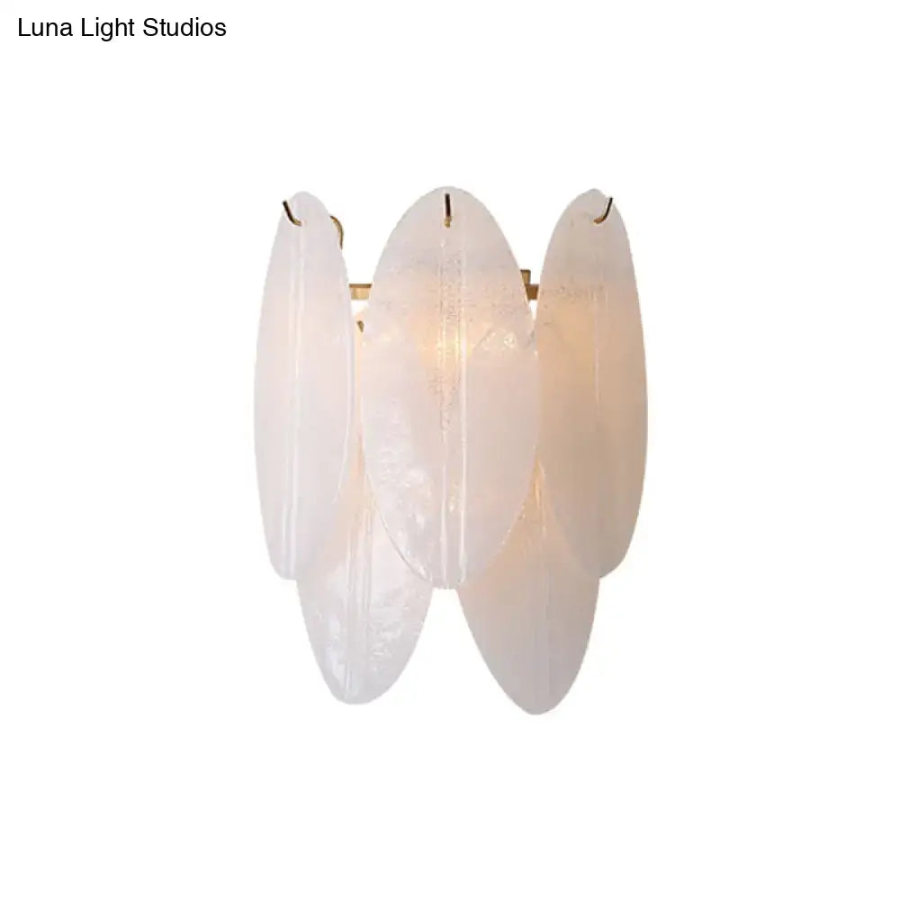 Modern oval white glass wall sconce featuring delicate opaline glass with subtle veining and a soft glow for hallways