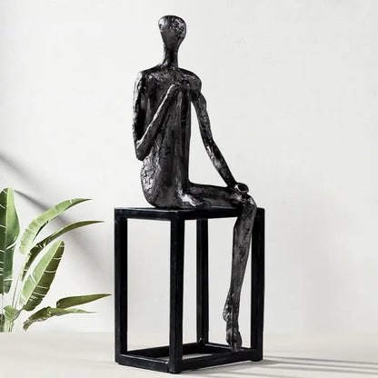Modern oxidized silver abstract thinkers sculpture featuring black matte finish seated on minimalist black cube base decorbites abstract thinkers