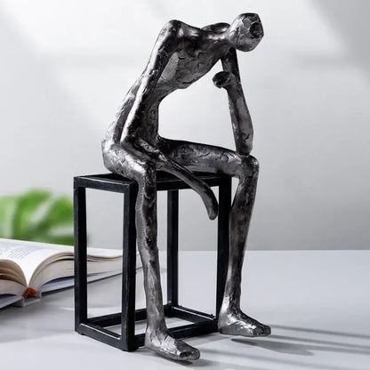 Silver-toned abstract thinkers sculpture with textured metallic finish by decorbites ideal for modern living room decor